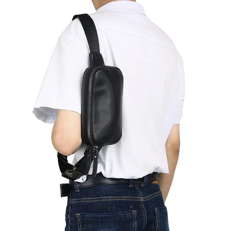 Men's small leather crossbody bag in cowhide showing compact dimensions and urban simplicity styling