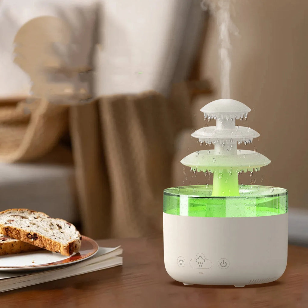 White Cloud Rain ultrasonic humidifier and essential oil diffuser with colourful LED lights on a table.