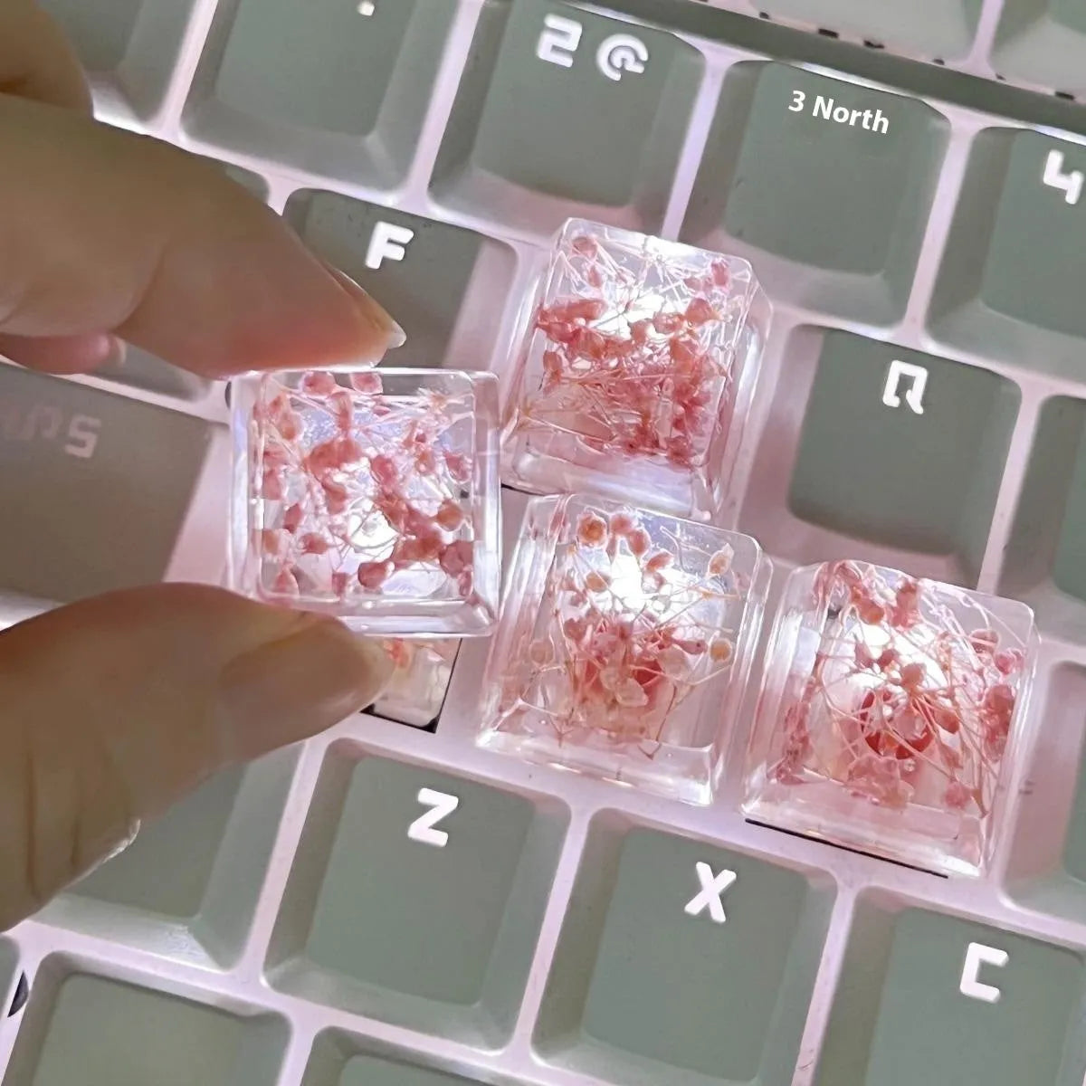 Translucent resin starry sky keycap with glitter particles measuring 1.8cm by 1.2cm