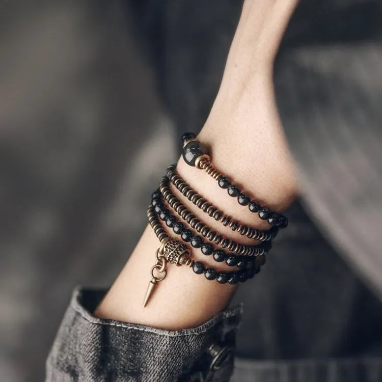 Black multi-layered beaded bracelet with colourful geometric and natural style beads.