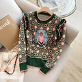 Green printed women's sweater with a loose fit and regular-length sleeves.