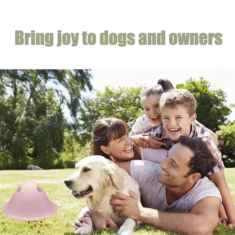 Large green interactive dog puzzle toy with treat slots on a floor.
