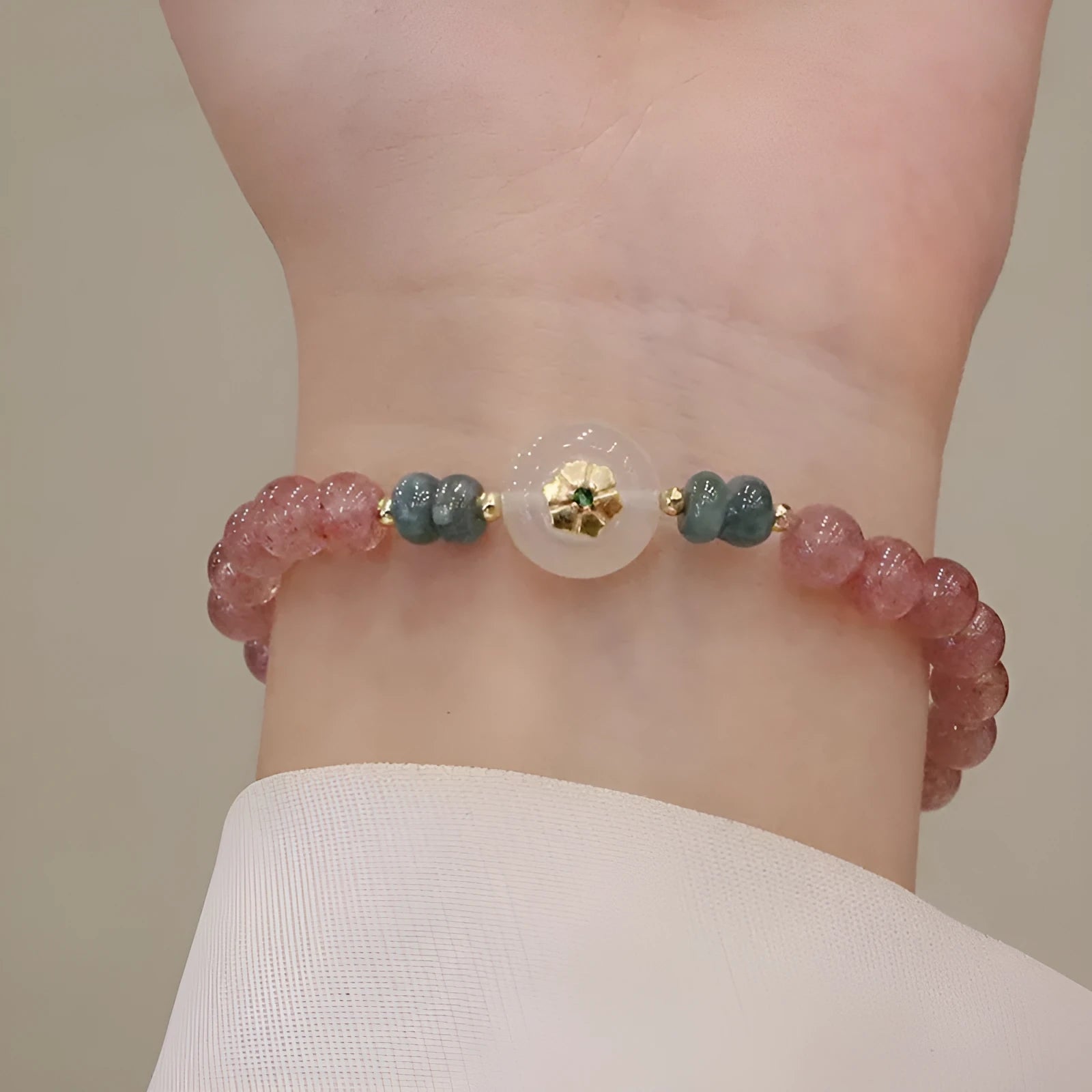 Women's strawberry quartz bracelet with blue water emerald pendant and peace buckle clasp