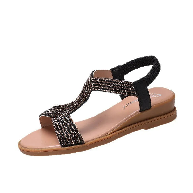 Women's gold patent leather sandals with rhinestone decoration and a non-slip sole.