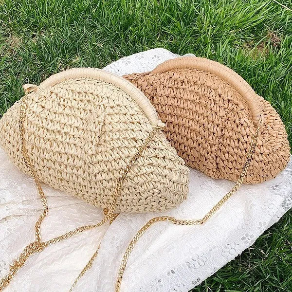 Women's khaki paper straw shoulder bag with a chain strap and shell shape.