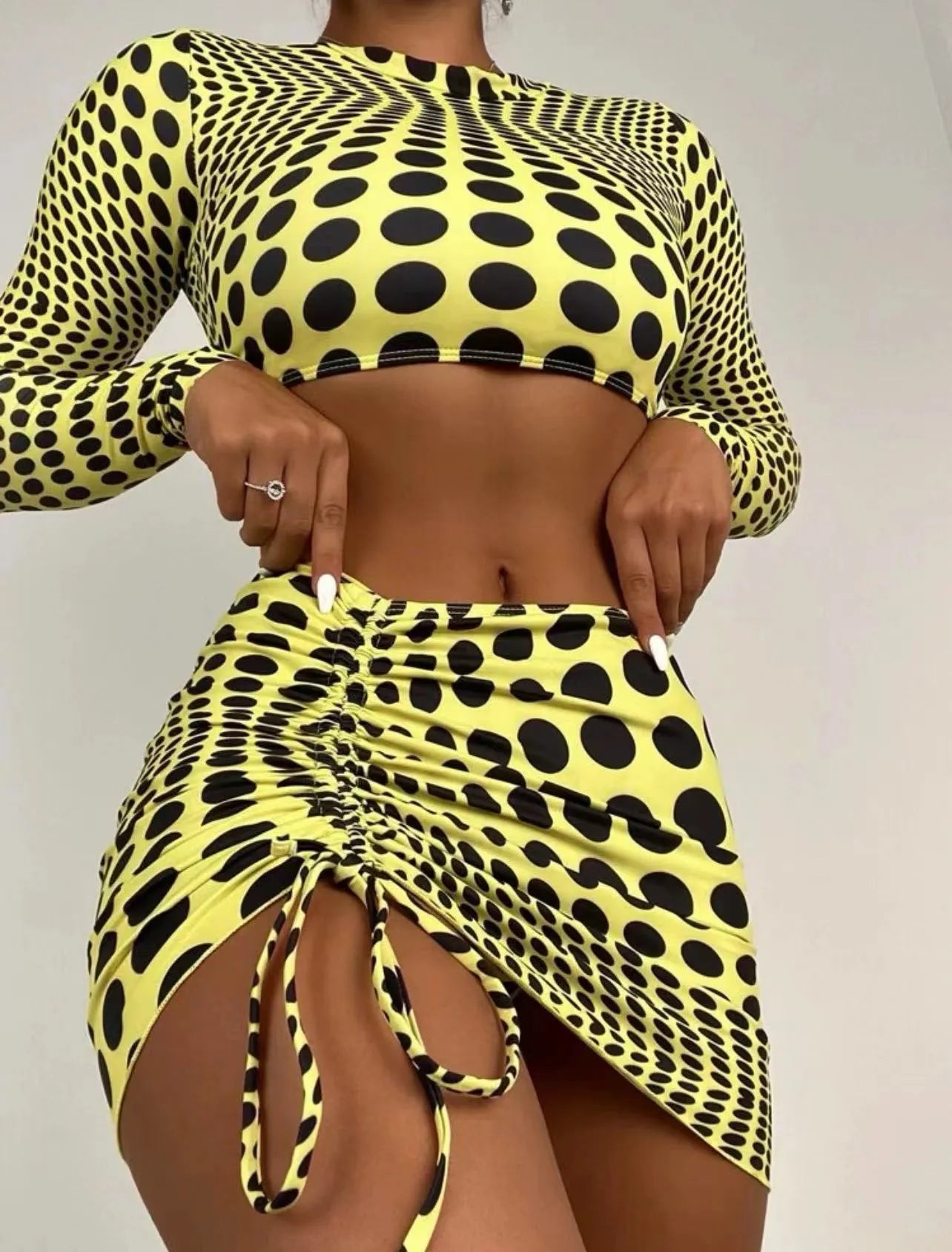 Women's green polka dot three-piece swimsuit set showing top, skirt and bra