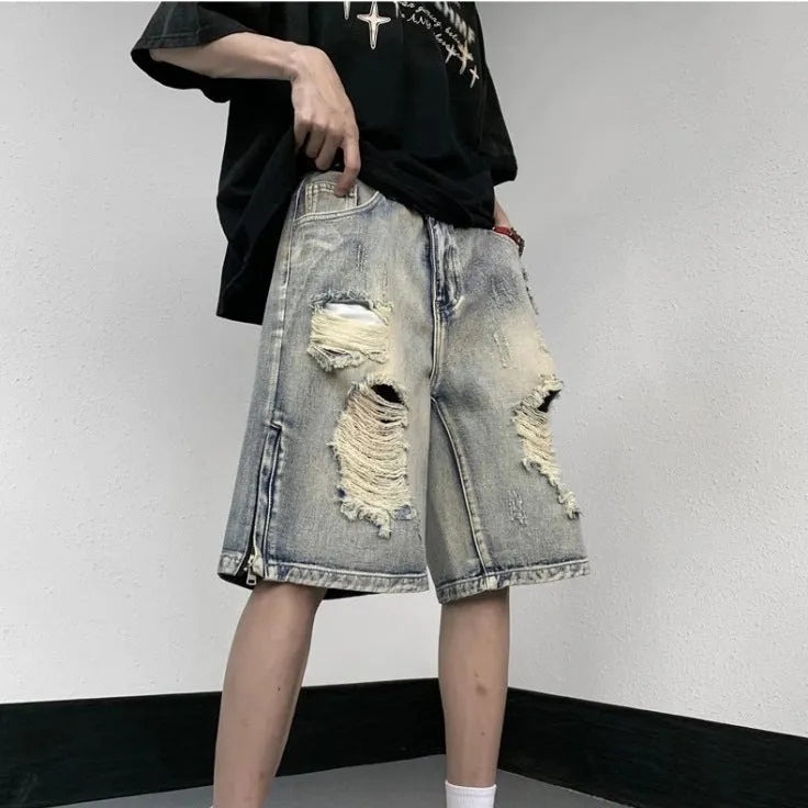 Blue retro tattered denim shorts with a wide leg loose fit on a neutral background.