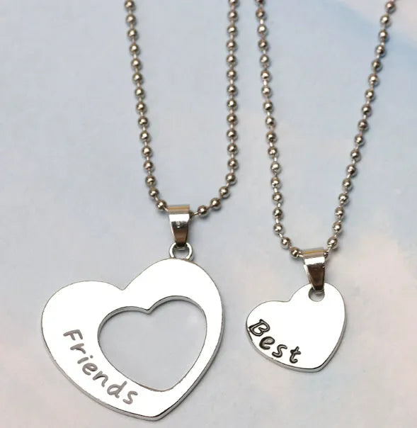 Two-piece silver alloy necklace set with heart-shaped pendants and cross chains in a love design