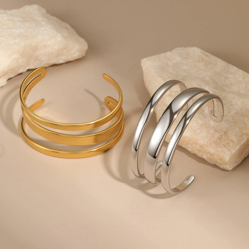 Stainless steel simple opening bracelet with geometric line design in gold or steel electroplated finish