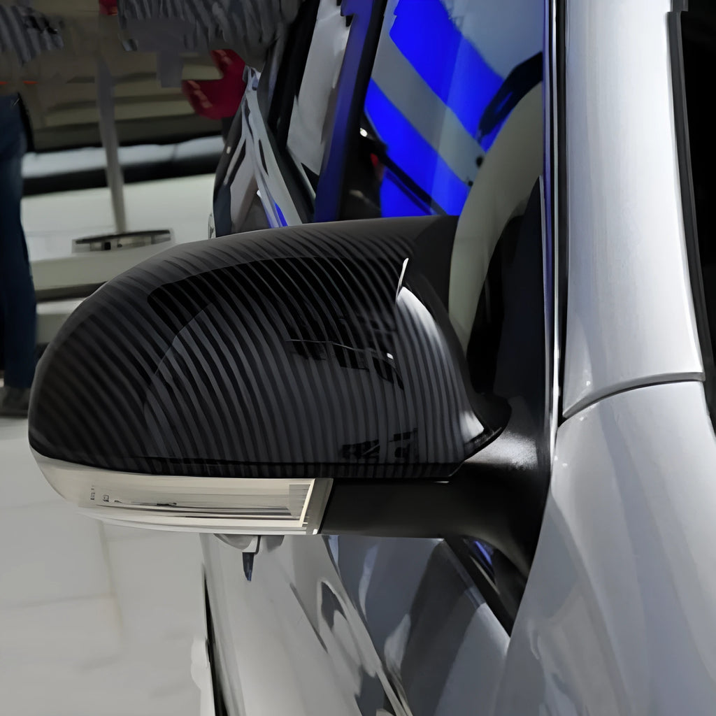 Bright black plastic mirror reflector shell pair for a Volkswagen Sagitar car.