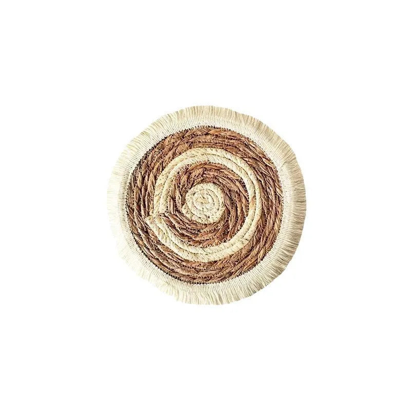 Round Japanese straw placemat with decorative tassels in natural papyrus colour, showing handwoven texture