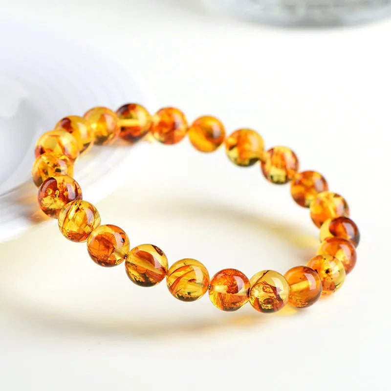 Natural yellow piebald amber bracelet with geometric beads and water purification properties