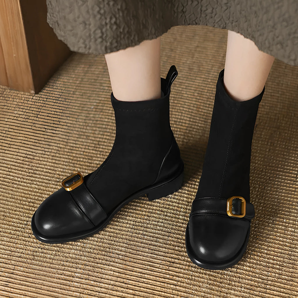 Women's black low heel Martin boots with lace-up front and belt buckle detail.