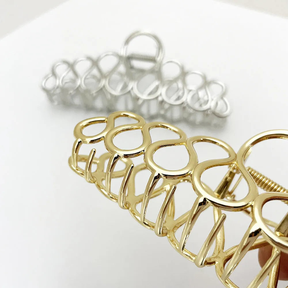 Minimalist large alloy hair clip with tassel in gold or silver for updo hairstyles.
