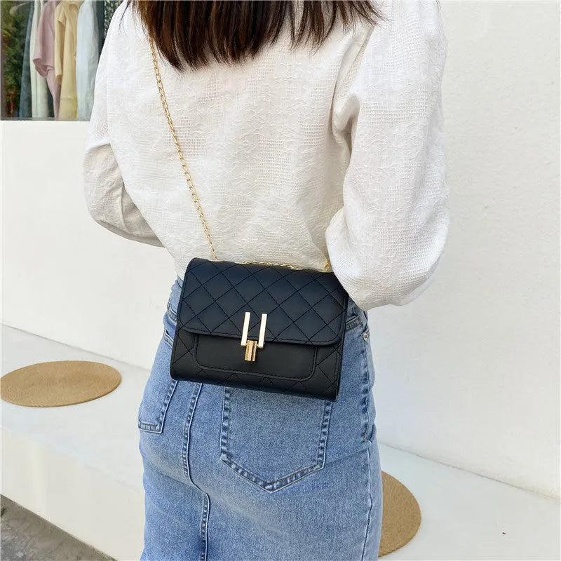 Women's crossbody bag with diamond lattice pattern, adjustable 120cm strap, shown in black colour with dimensions 17.5cm width