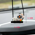 Resin cartoon astronaut car pendant hanging from a rear-view mirror.