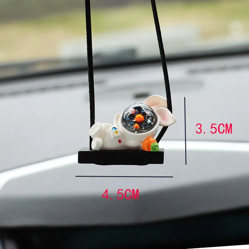 Resin cartoon astronaut car pendant hanging from a rear-view mirror.