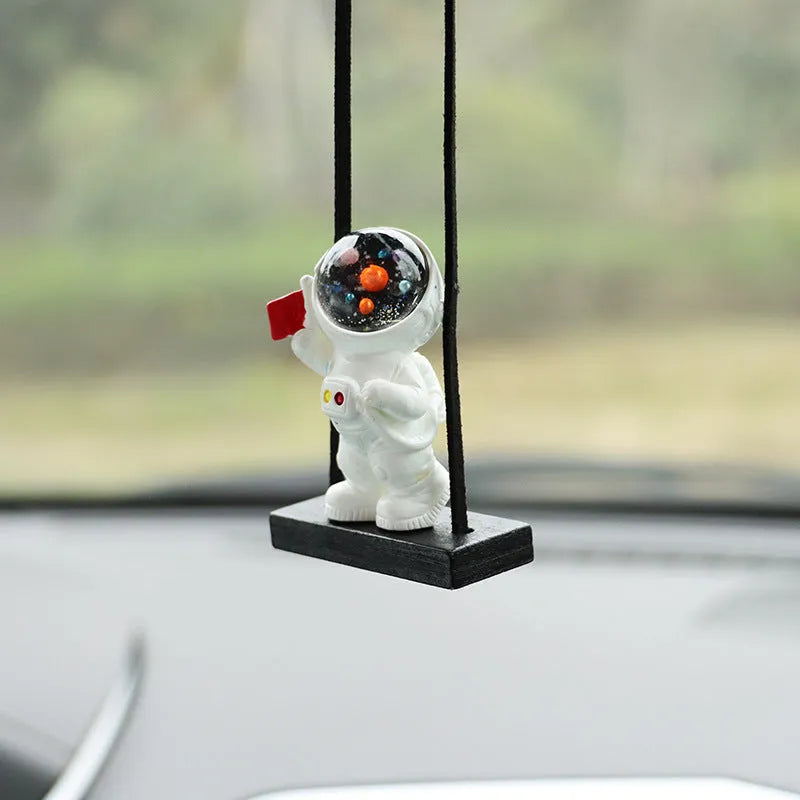 Resin cartoon astronaut car pendant hanging from a rear-view mirror.
