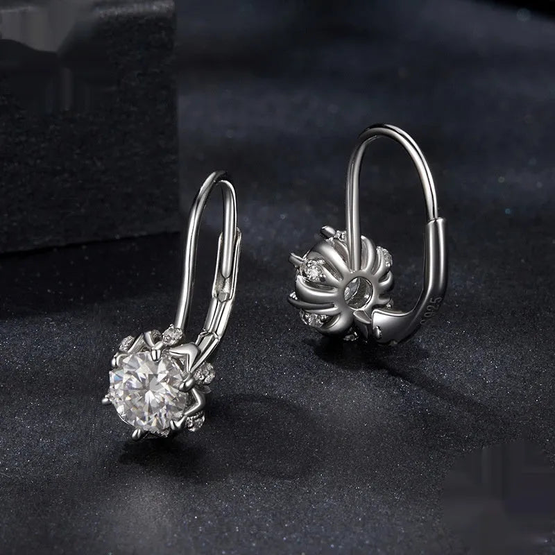 Close-up of a sterling silver floral ear clip with moissanite stone and white gold plating