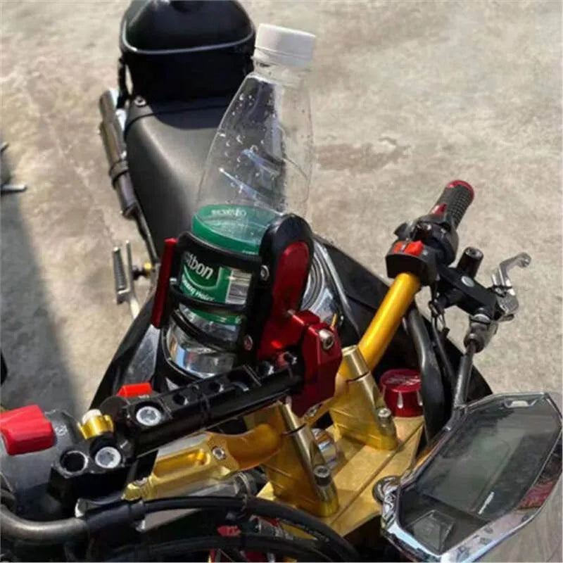 Modified water bottle cage mounted on Honda X-ADV scooter bumper in titanium colour