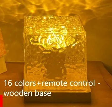 USB rechargeable LED water ripple night light with remote control on a table.