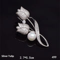 Close-up of a silver tulip coloured flower brooch with micro-inlaid zircon stones on a dark background.