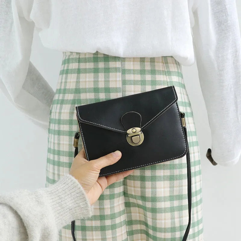 Retro soft-surface crossbody messenger bag with flap closure and lock detail in wine red colour