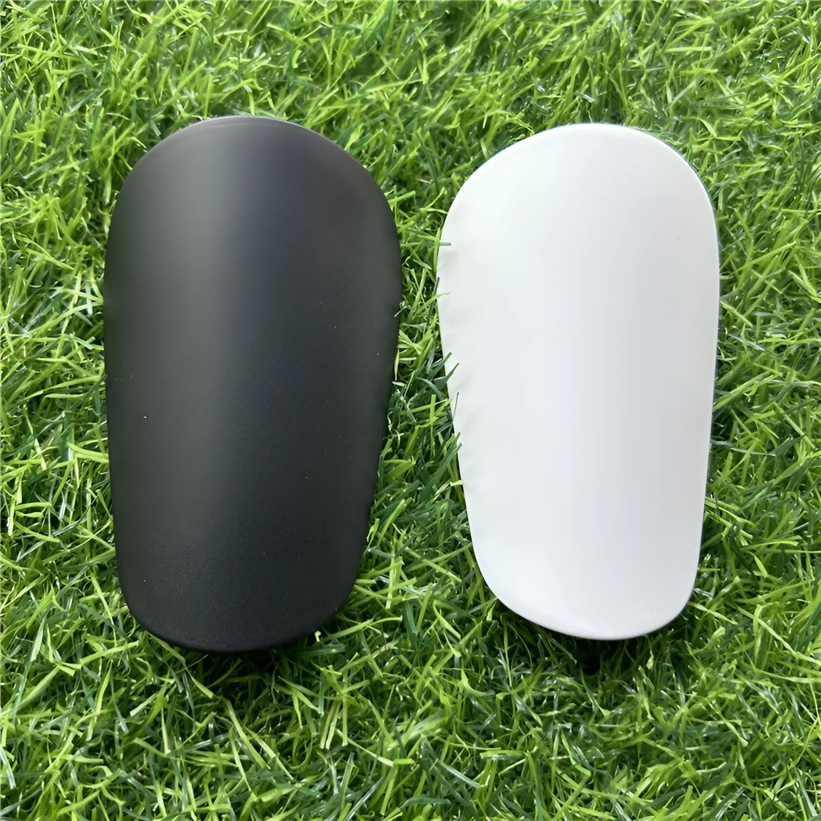Extra small mini football shin guards in black and white measuring 8x5cm