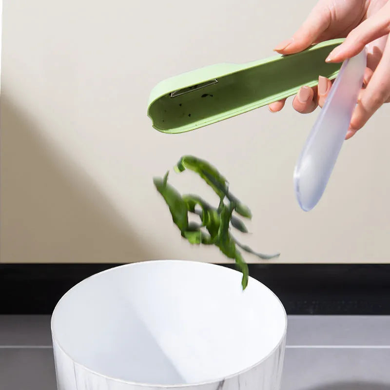 Green kitchen peeler with storage tube and stainless steel blade for fruit and vegetables