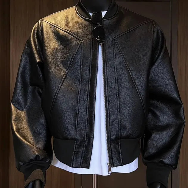 Man wearing a black PU leather jacket with litchi grain texture, showcasing its 100cm extended length and light business style fit.