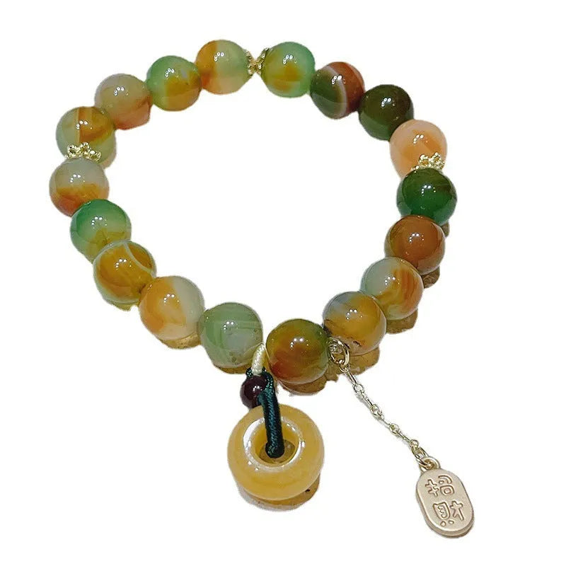 Yellow peacock agate and topaz bracelet with a peace buckle clasp and a lutong agate charm.