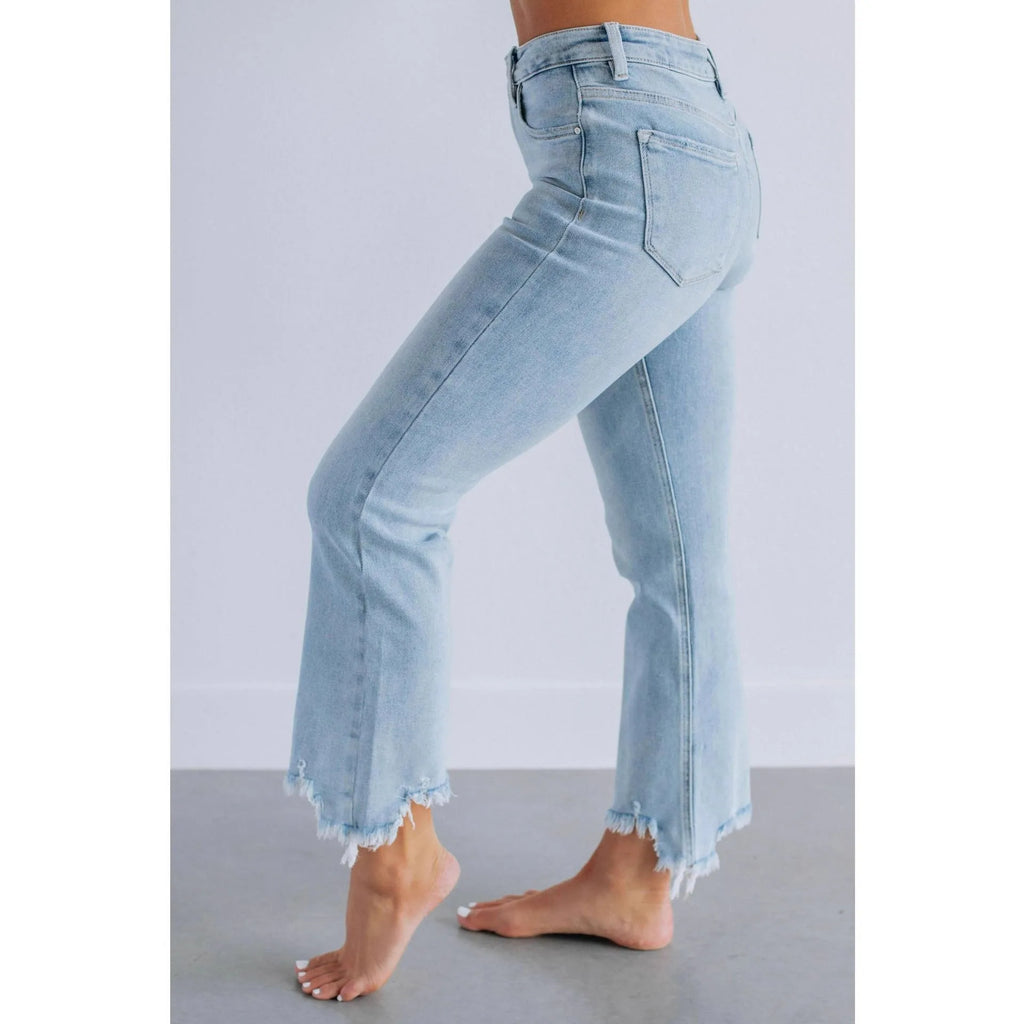 Women's hand-worn denim trousers in dark blue, showing 100% cotton fabric and casual fit