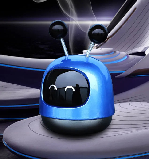 Blue robot car decorative ornament clipped to a car air vent as an aromatherapy diffuser.