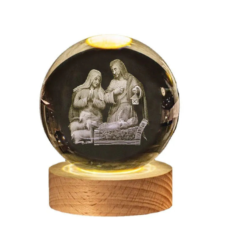 White crystal sphere on wooden base with warm glow, showing religious symbols including cross and prayer hands