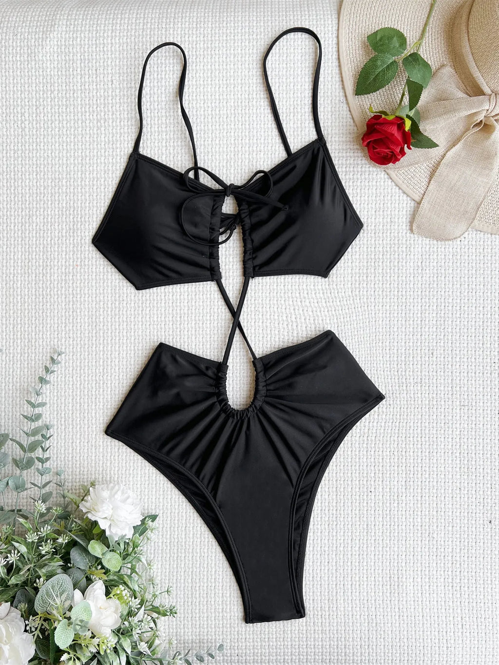 Women's sleeveless hollow back one-piece swimsuit in black on a mannequin