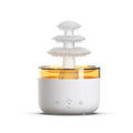 White Cloud Rain ultrasonic humidifier and essential oil diffuser with colourful LED lights on a table.