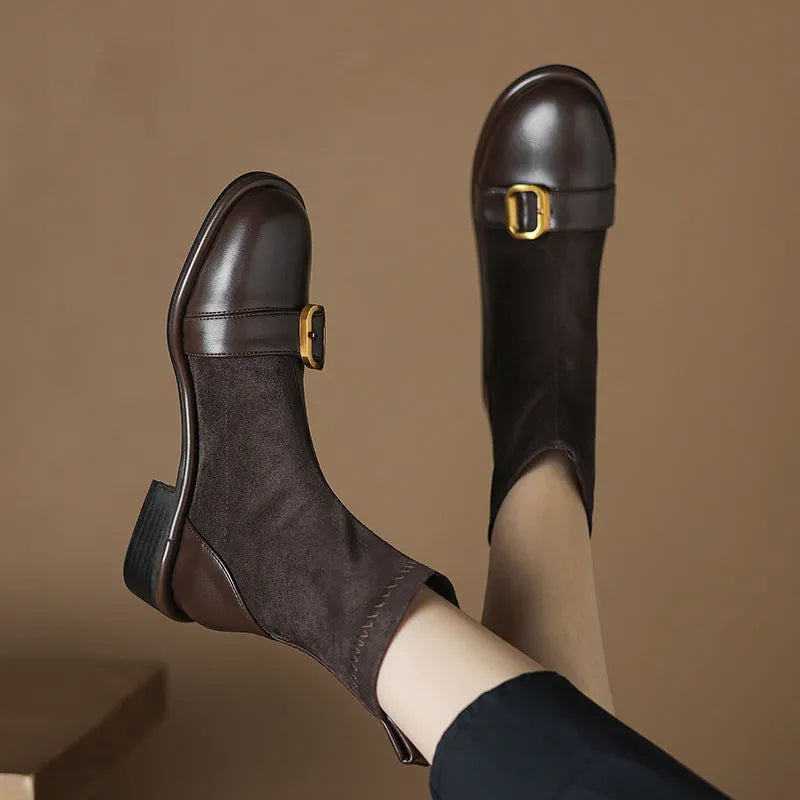 Women's black low heel Martin boots with lace-up front and belt buckle detail.