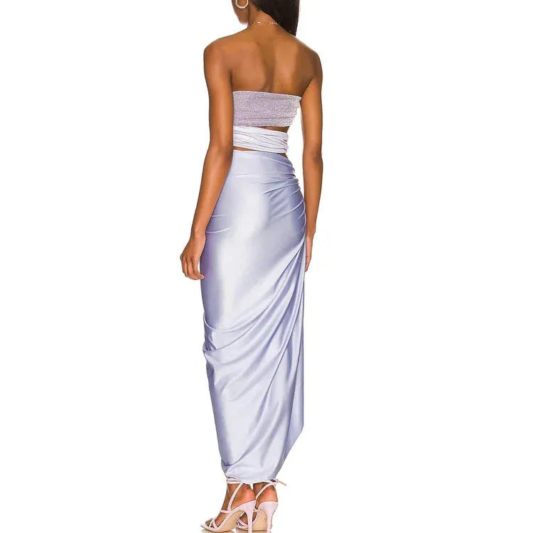 Purple one-piece swimsuit with high-cut legs and a matching wrap skirt laid flat.