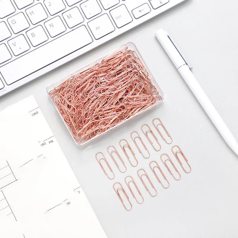 Rose gold coloured heart-shaped metal paper clips, 28mm size, in a box of 100 pieces.