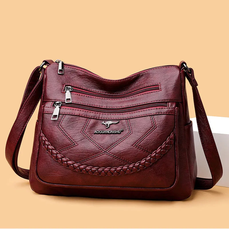 Black soft PU leather shoulder bag with crossbody strap, showing 30cm width and zippered internal organiser