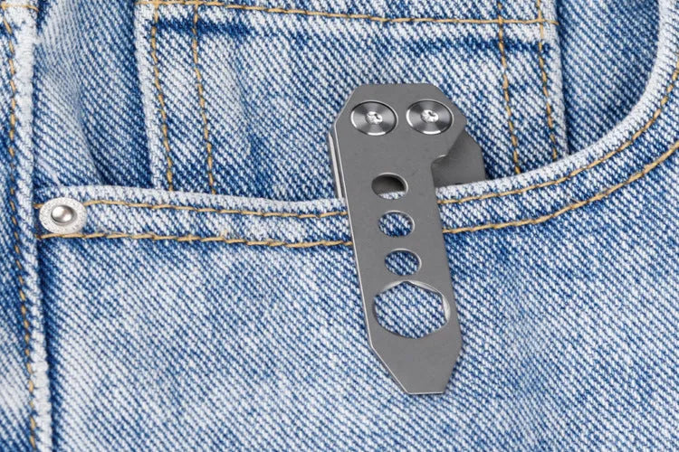 Titanium multi-function crowbar tool with screwdriver tip and bottle opener, shown in stone wash and gun grey finishes.