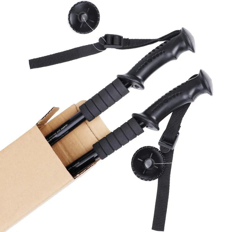 A pair of adjustable silver aluminium trekking poles with various foot attachments on a hiking trail.