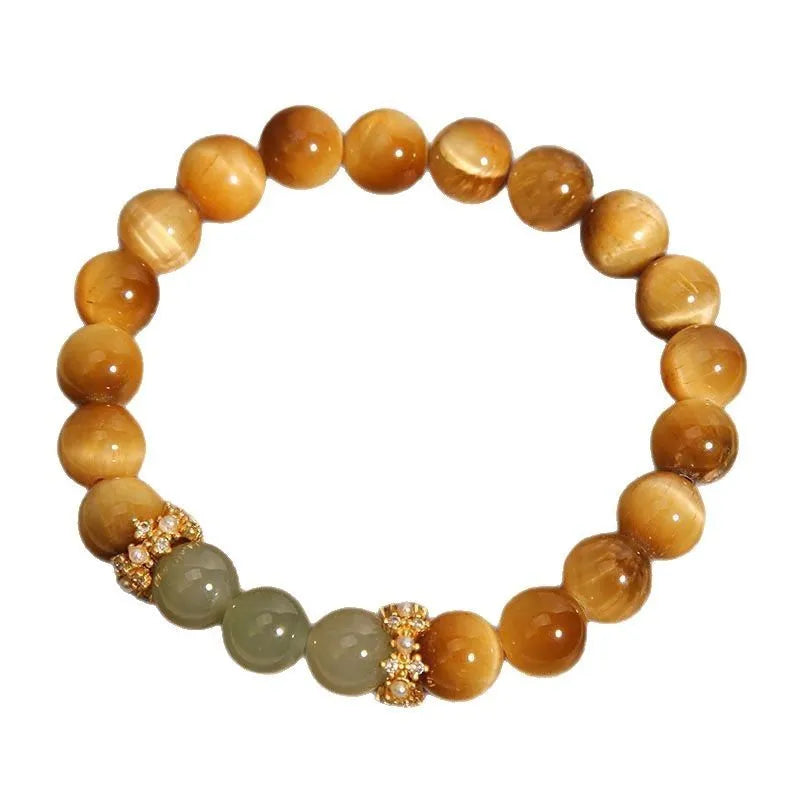 Natural yellow tiger's eye stone bead bracelet with gold gourd charm on a white background.