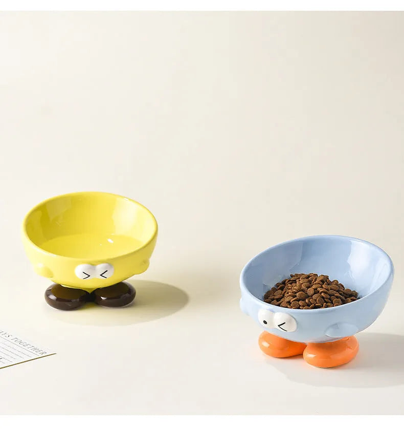Blue slanted ceramic pet bowl for cats and dogs on a plain background.