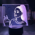 Slim acrylic 3D night light with LED illumination on a table.