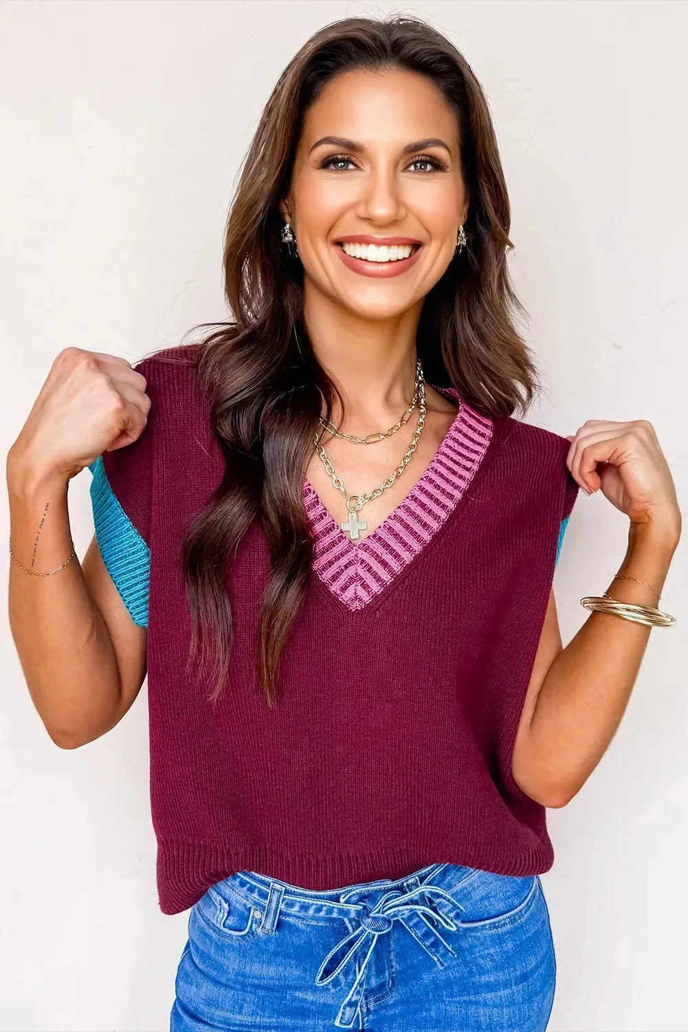 Burgundy loose V-neck sweater with cuffed short sleeves and light contrast trim laid flat.