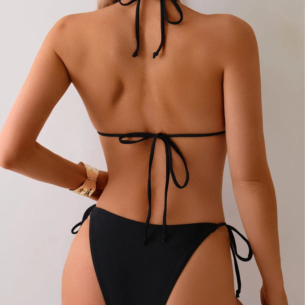 Black women's bikini swimsuit with metal bead accents and split design for swimming