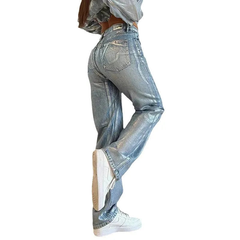 High waisted straight leg blue denim jeans with contrast stitching on a model.