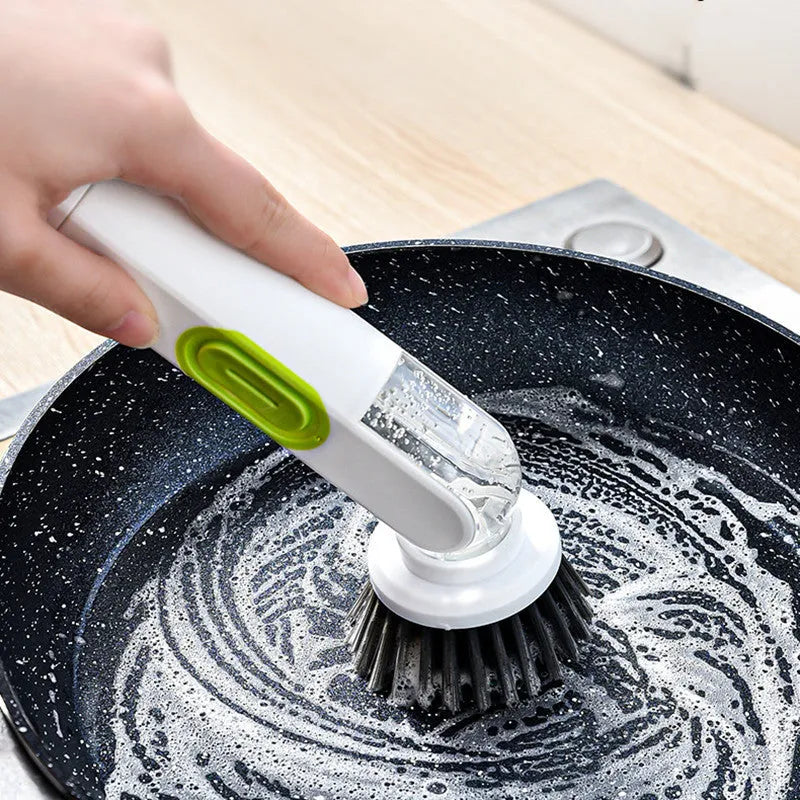 Long-handle kitchen cleaning brush with integrated soap dispenser and two removable brush heads, in white and red colour option.