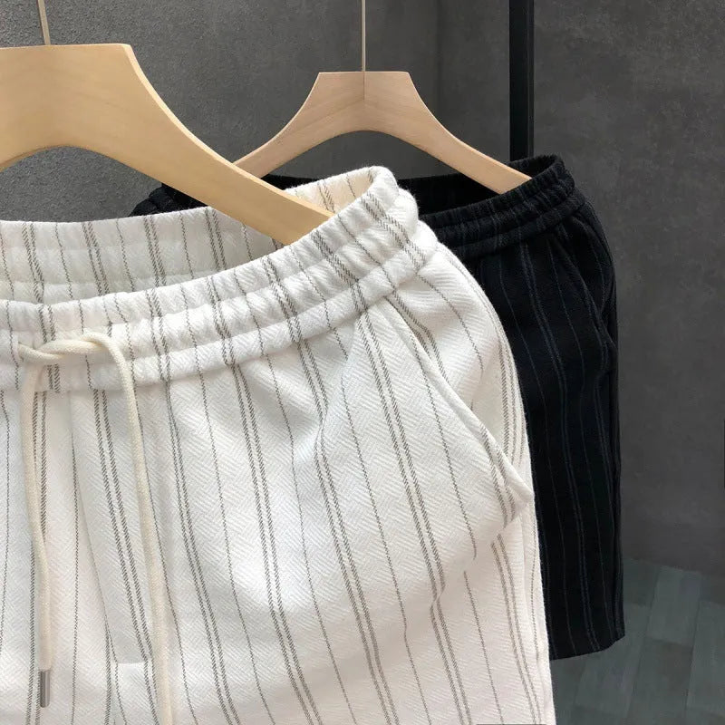 Men's black and white striped casual shorts with fleece lining, double-layer waistband, and ankle banding on straight-leg design